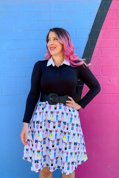 a model standing in front of a colorful painted wall wearing the cats a-line skirt