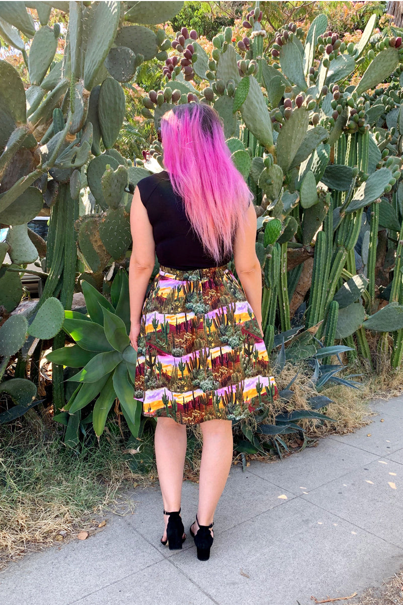 a back view of model standing in front of cacti wearing the desert dreams a-line skirt