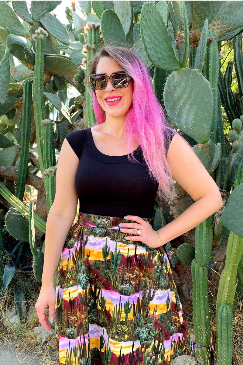 a model standing in front of cacti wearing the desert dreams a-line skirt