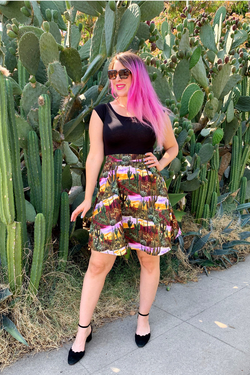 a model standing in front of cacti wearing the desert dreams a-line skirt