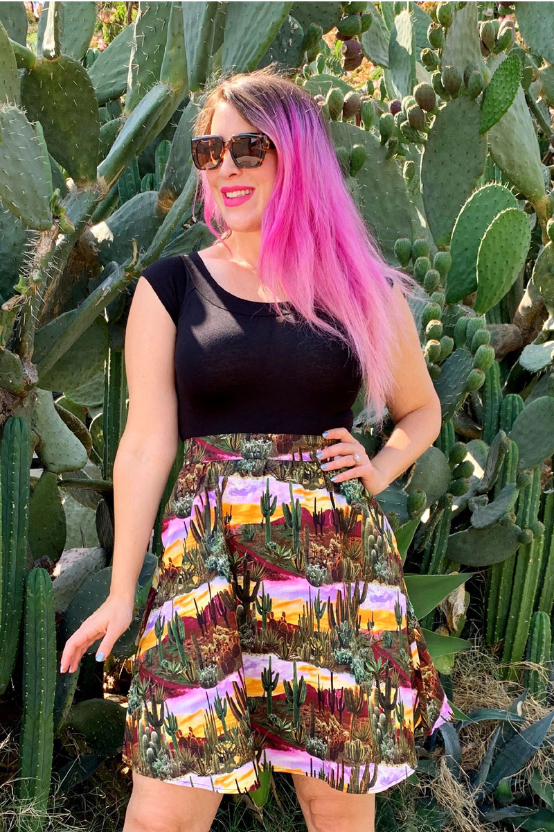 a model standing in front of cacti wearing the desert dreams a-line skirt