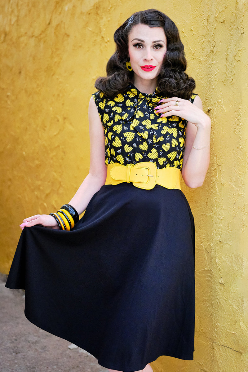 model standing in front of a yellow wall wearing our honey hives bow top
