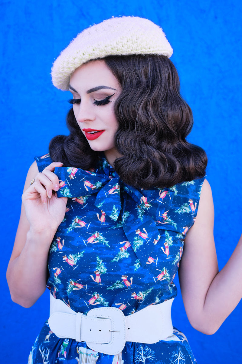 a close up of a model wearing our festive fox bow top