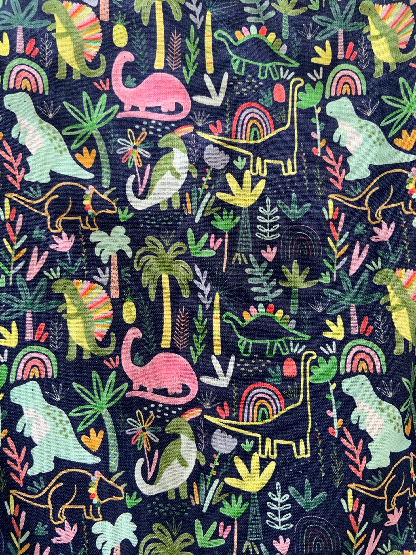 a close up of fabric for dinos and rainbows vintage dress