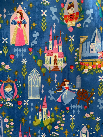 a close up of the fabric showing scenes from sleeping beauty with the castle, prince and princess