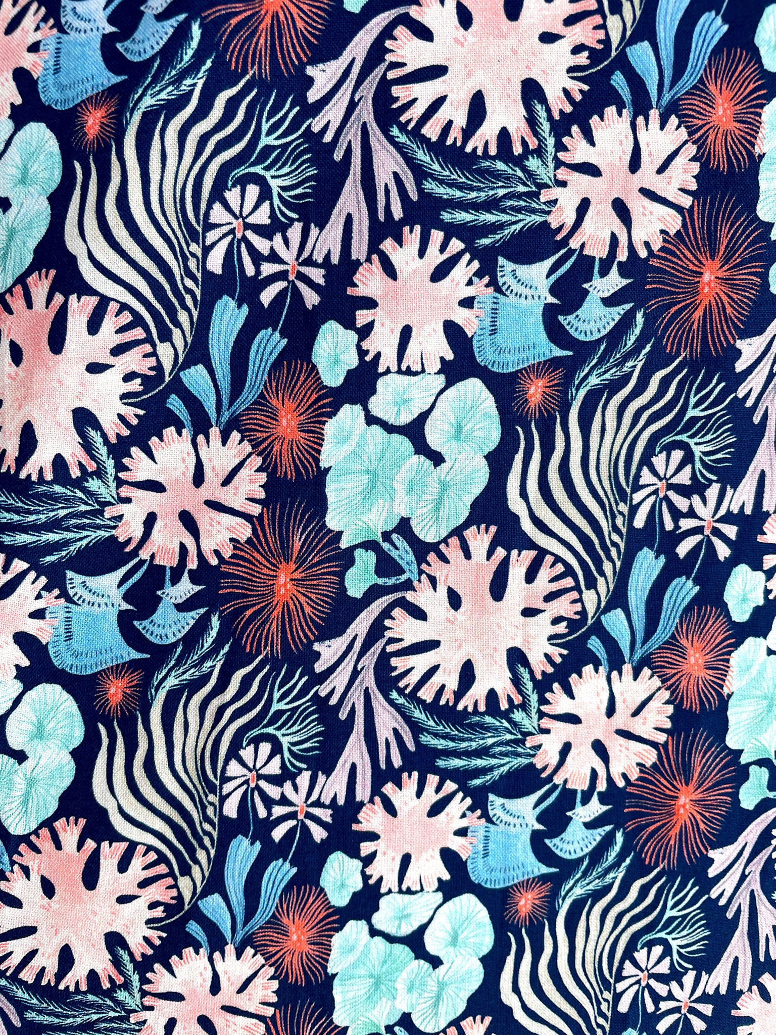 a fabric close up of the coral print