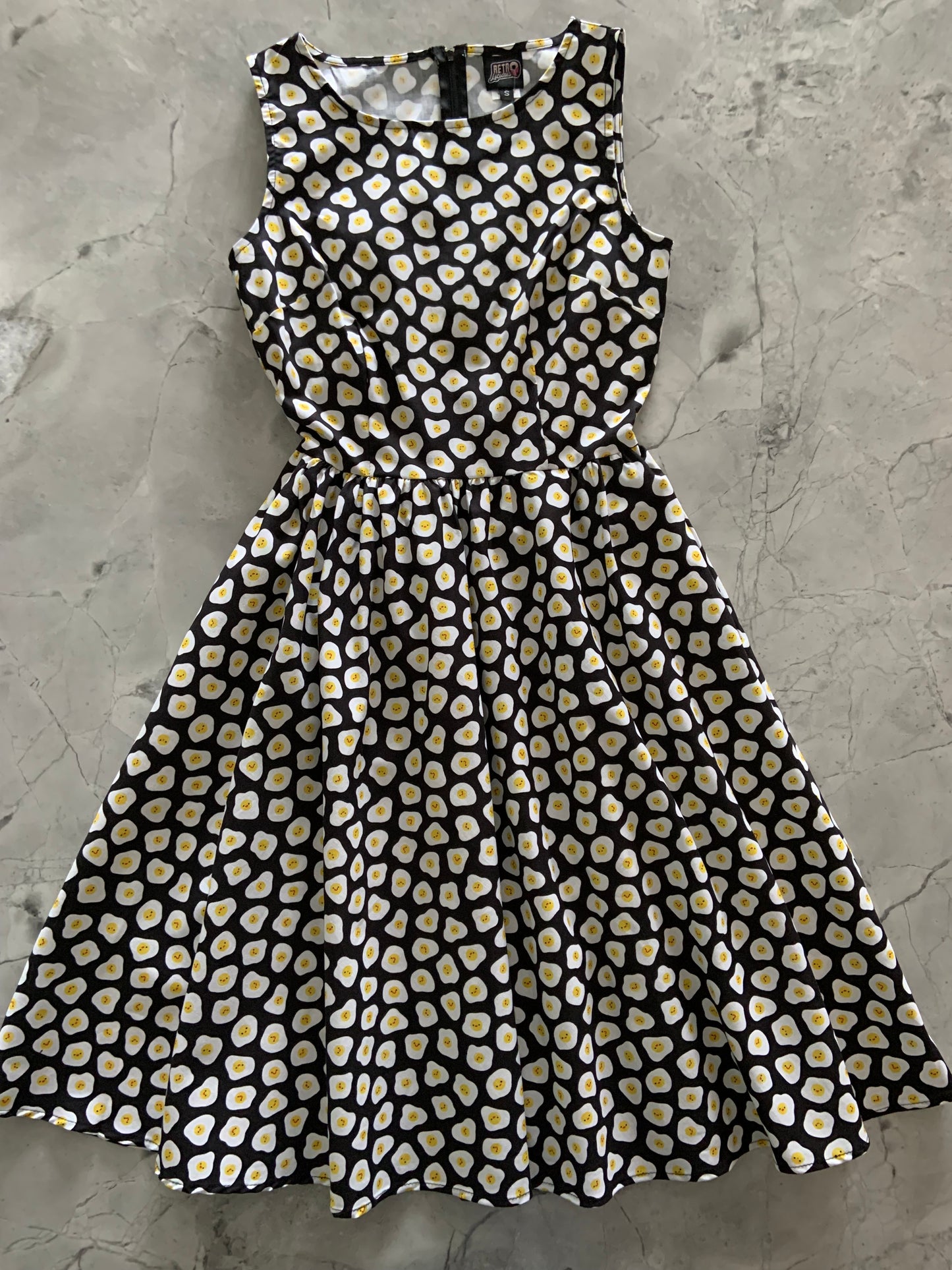 a flat lay of the front of the sunny side up vintage dress