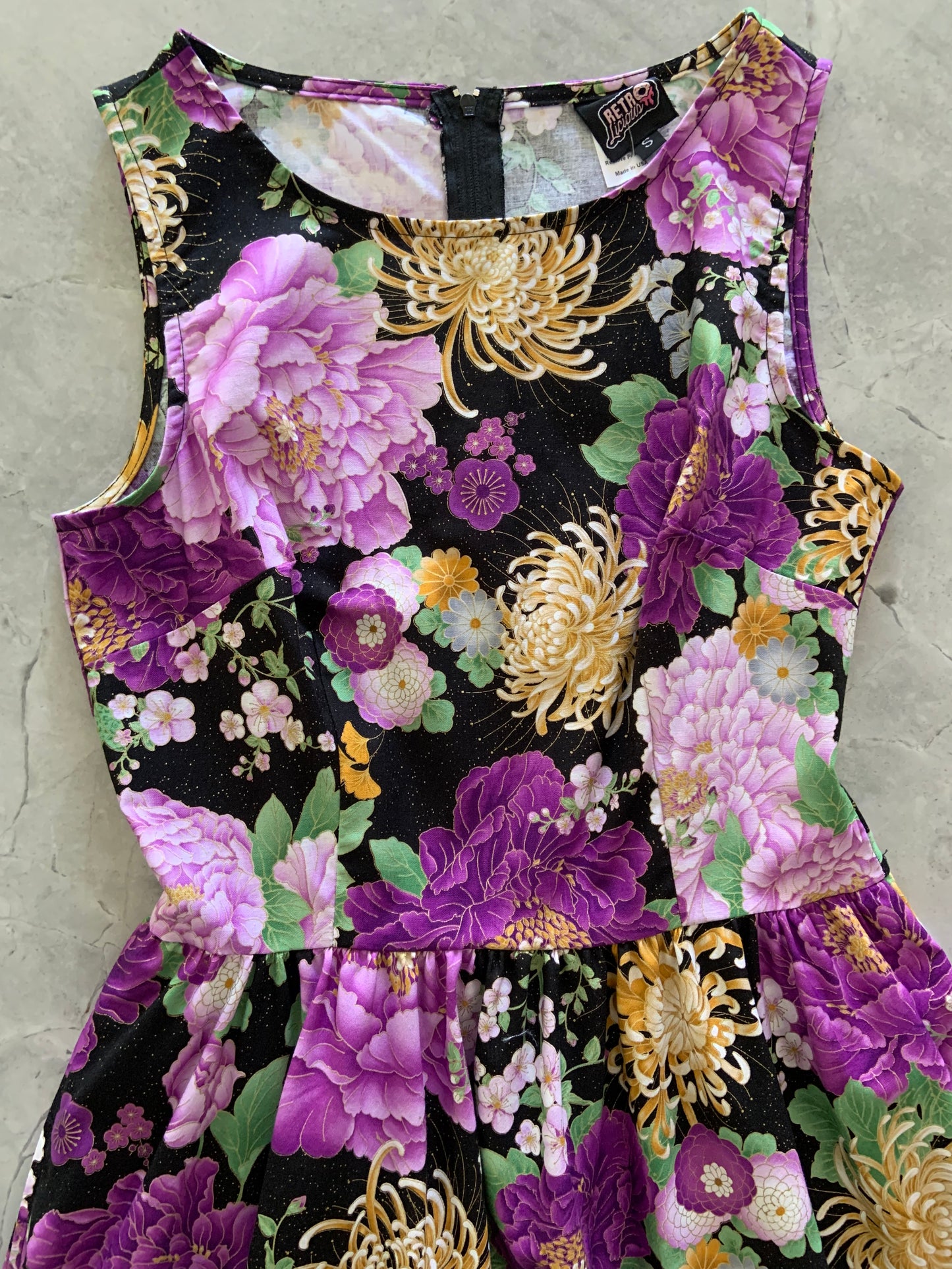 a close up of the bodice of the purple metallic floral vintage dress