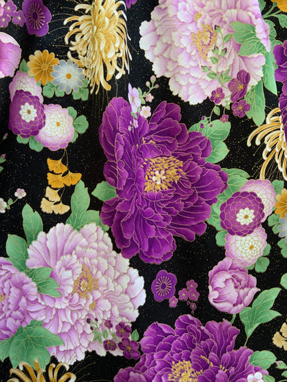 a close up of the fabric of the purple metallic floral vintage dress