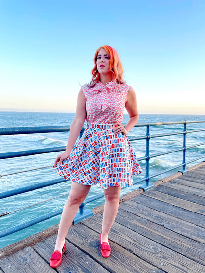 a full length of a model standing in front of the ocean wearing our umbrella bow top