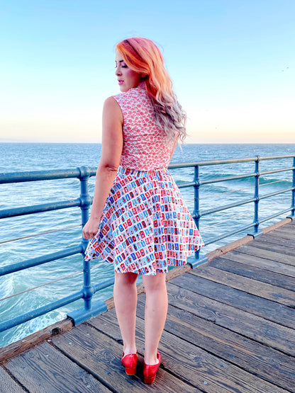 a back view of model standing on boardwalk with the ocean in the background wearing sunny days skater skirt
