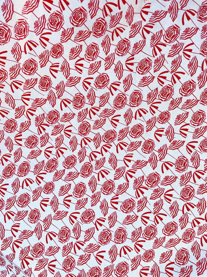 a close up of the fabric with red umbrellas on white background