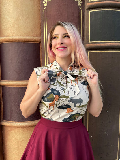 a close up of a model wearing the safari bow top and holding on to the ties of the bow