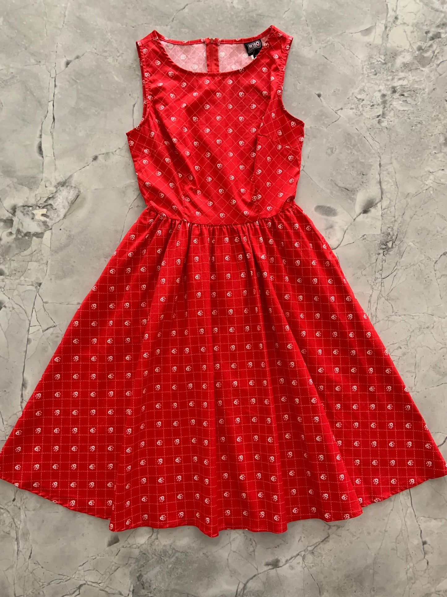a flat lay of red floral vintage dress