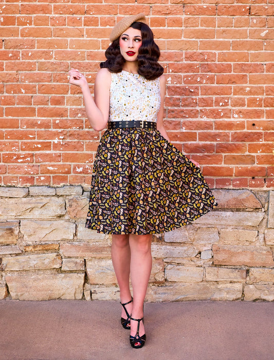 a photo of a model wearing a dress with upper half with snail print and skirt with a leaf print