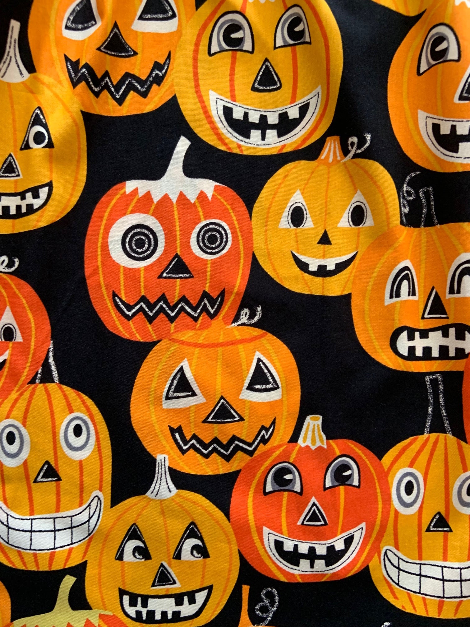 a close up of the fabric of jack-o-lanterns 
