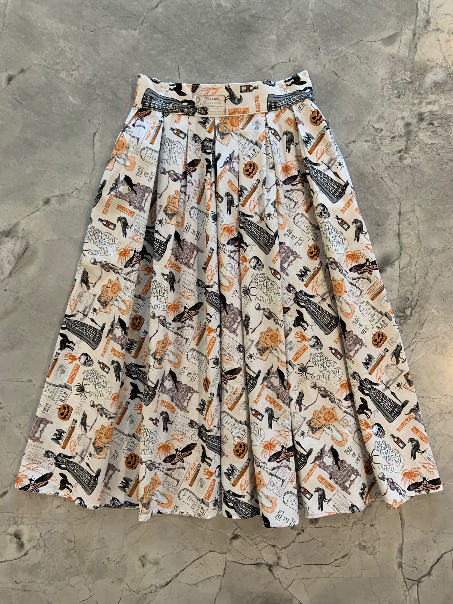 a flat lay of our Spooky dorist skirt showing the front of the skirt layed out flat