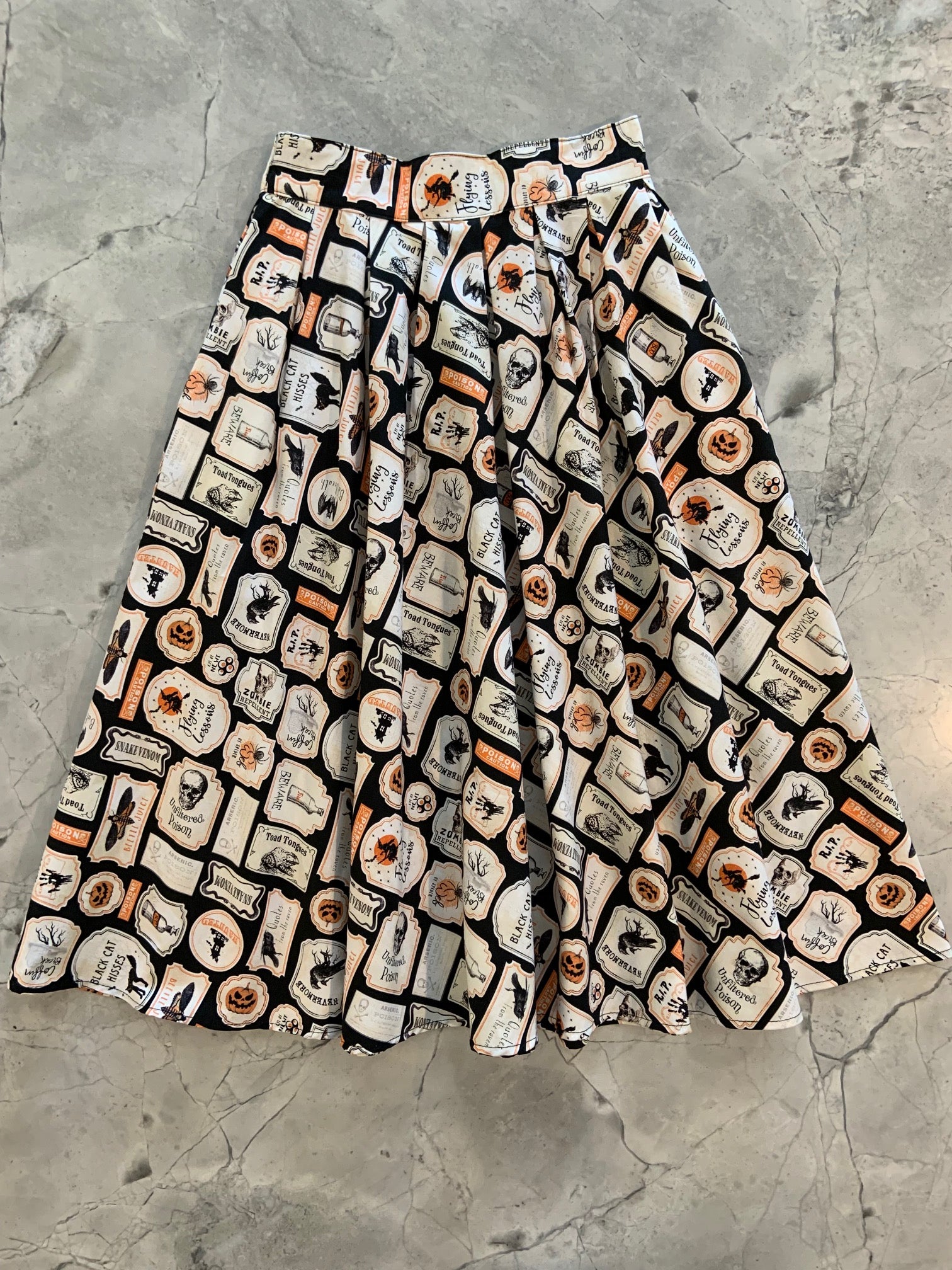 a flat lay of the halloween doris skirt showing the full skirt layed out flat