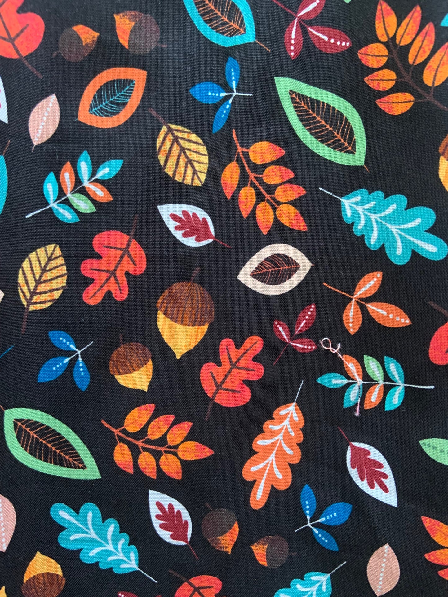 a close up of swatch of leaves and acorns margaret dress