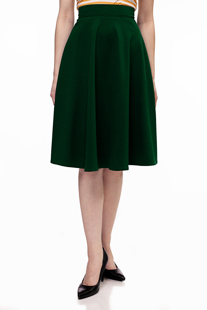 a close up of a model wearing charlotte skirt in green