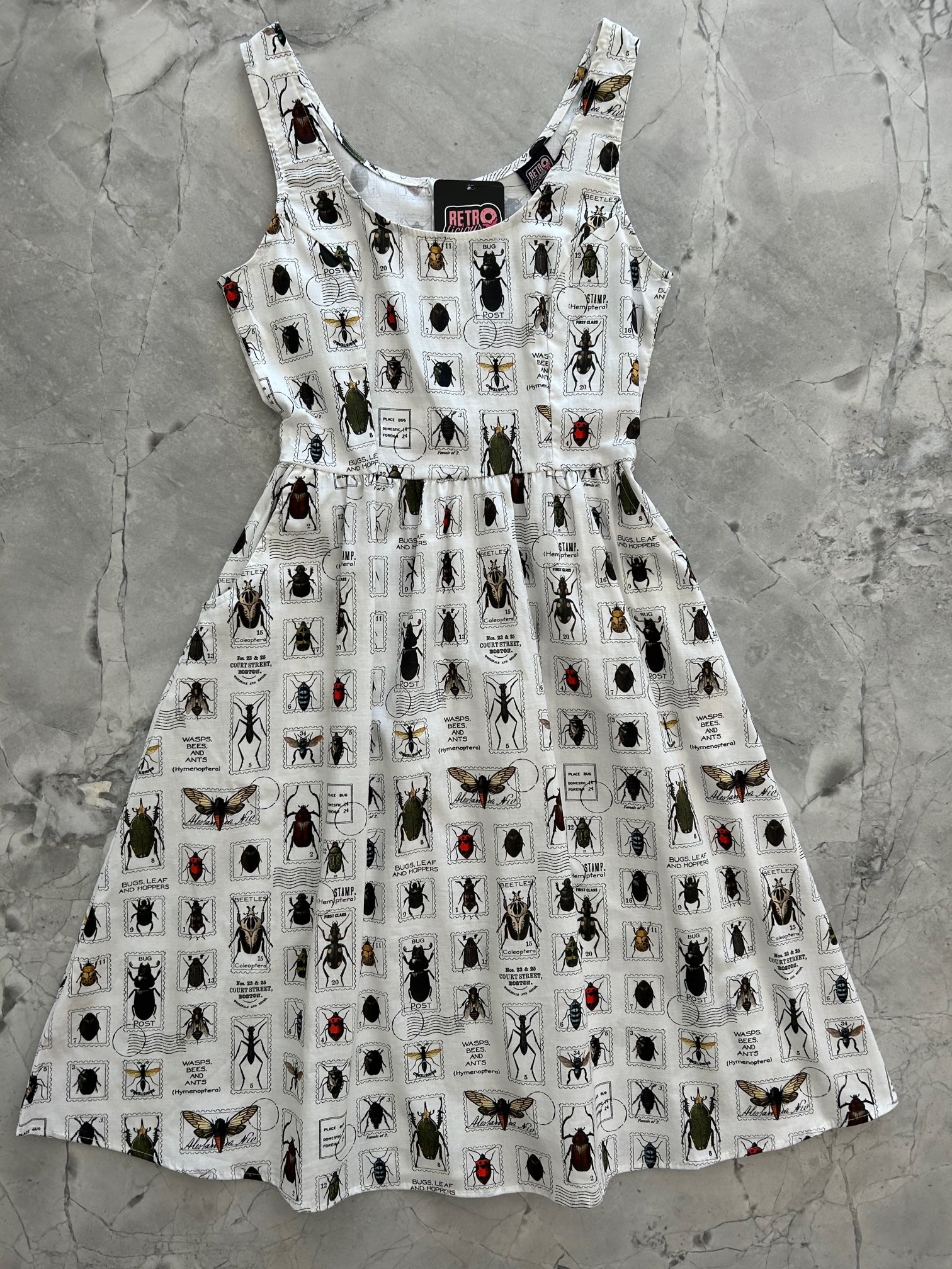 a flat lay of the front of the bug stamps fit and flare dress