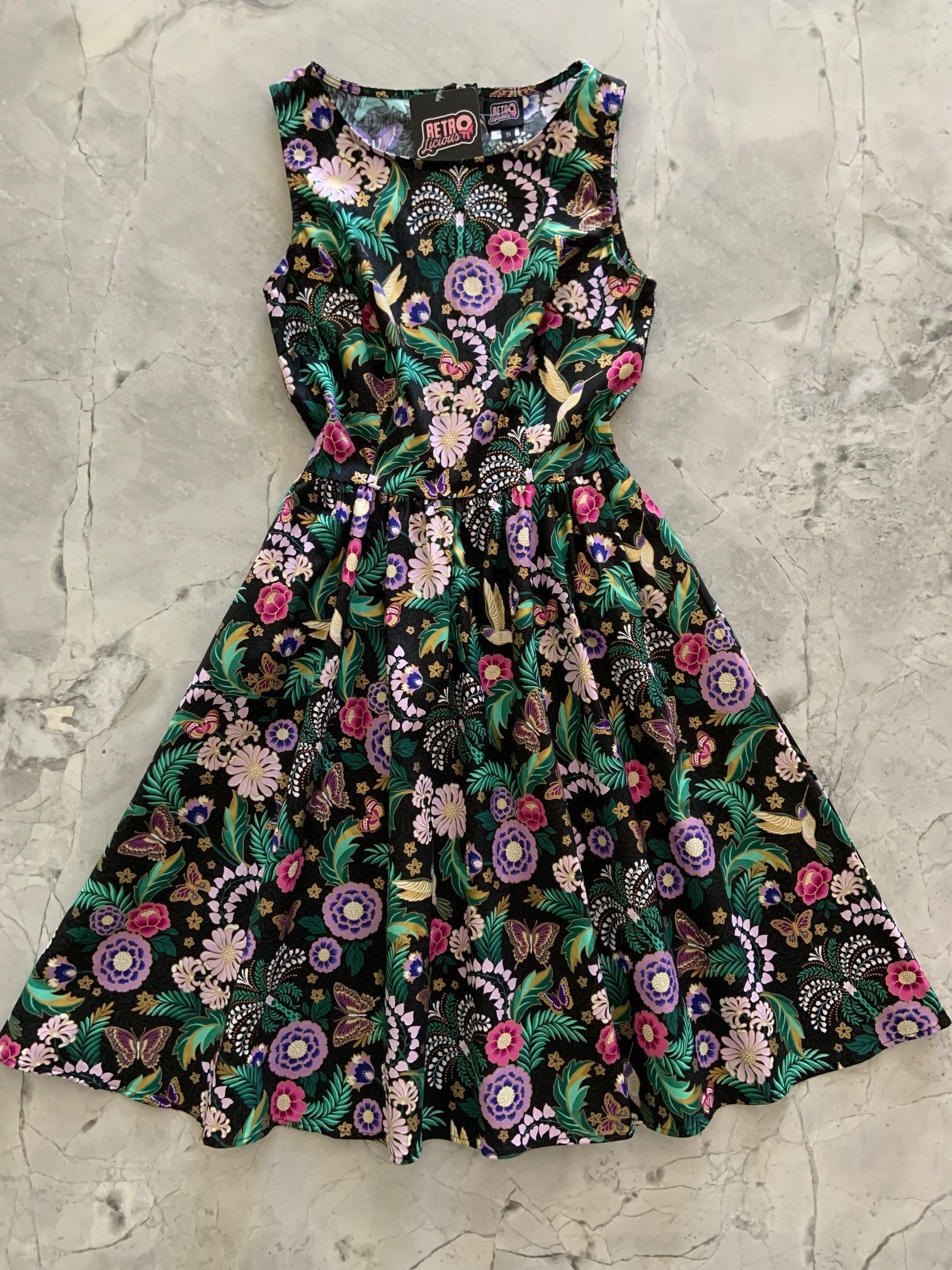 a flat lay of the front of the hummingbird vintage dress