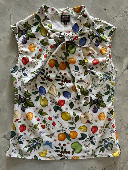 a flat lay of our bow tie blouse with fruits and butterflies fabric