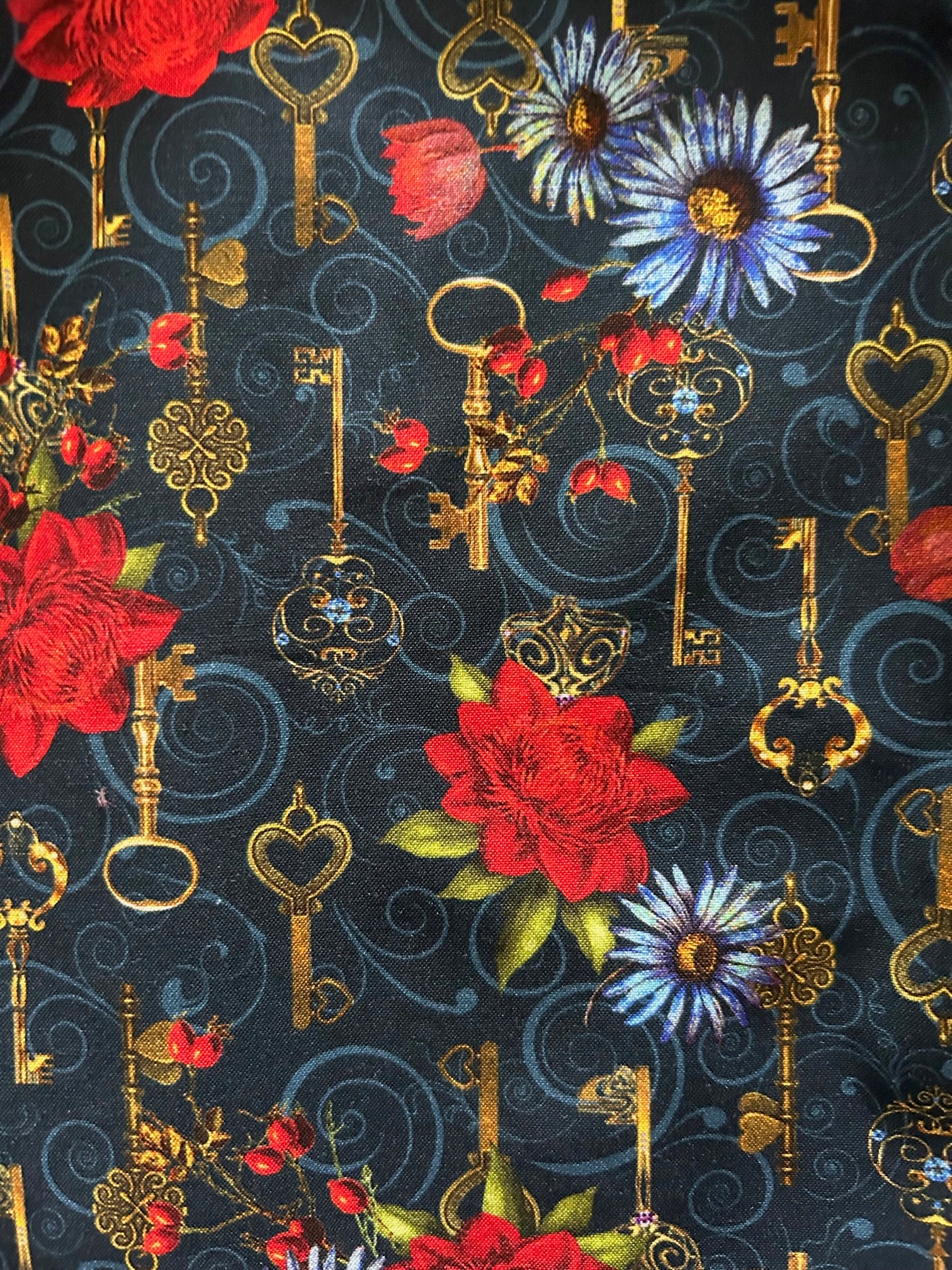 a close up of the fabric showing keys and flowers
