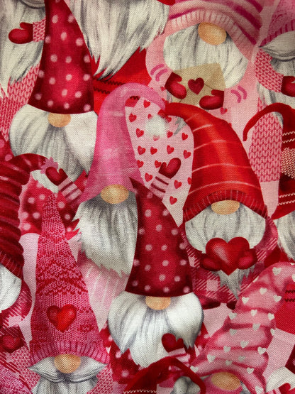 a close up of fabric showing pink gnomes