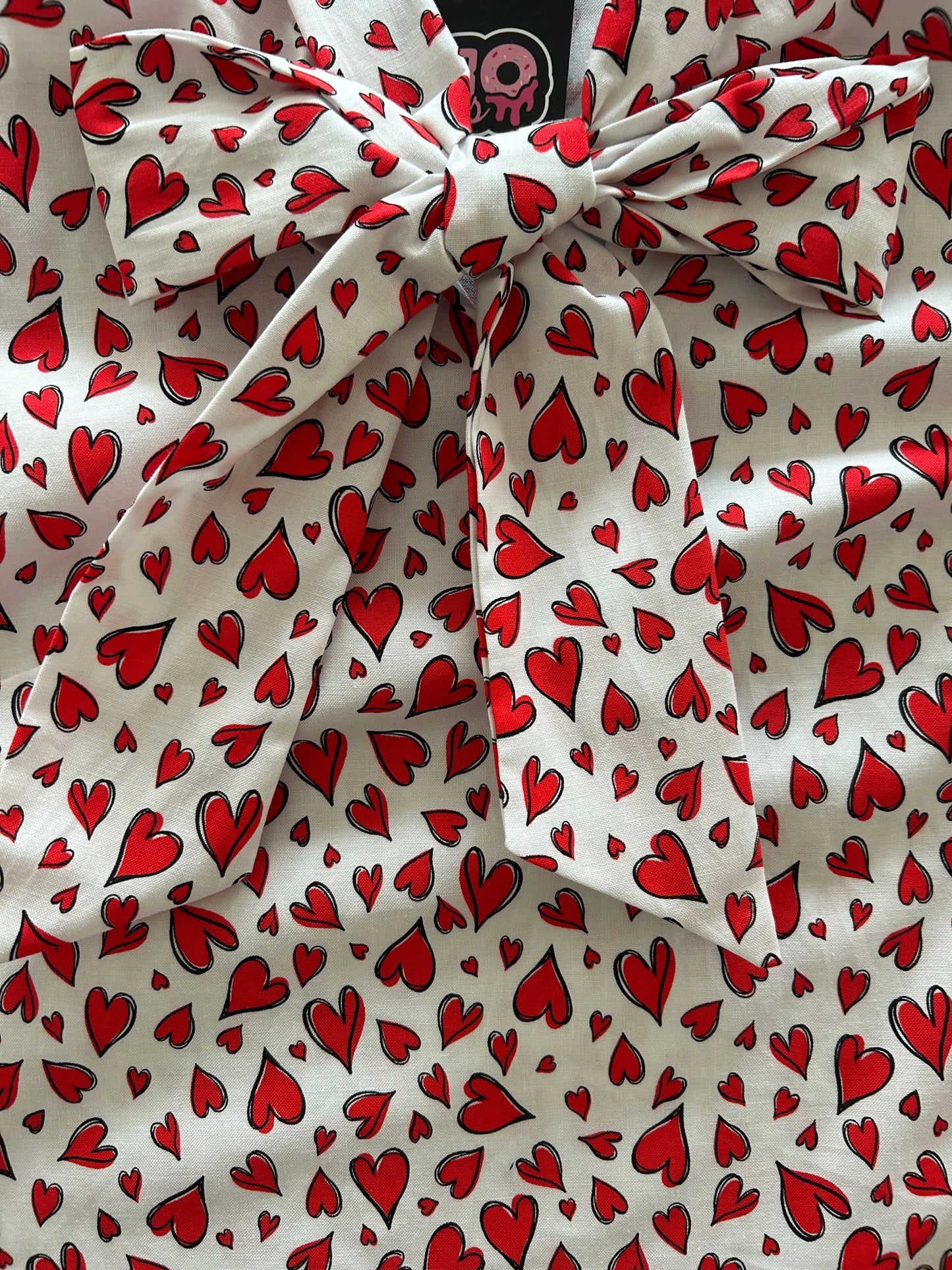 a close up of our hearts bow top