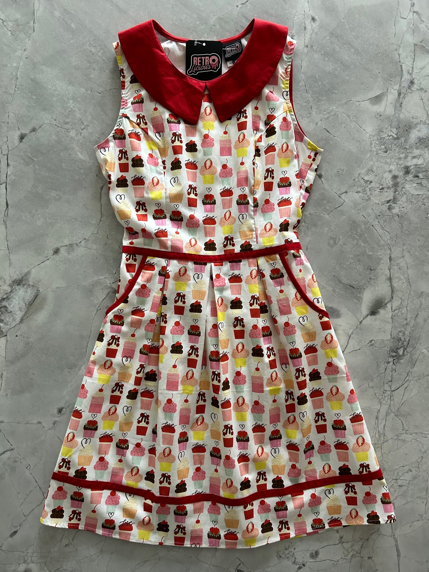 a flat lay of the cupcake collared dress