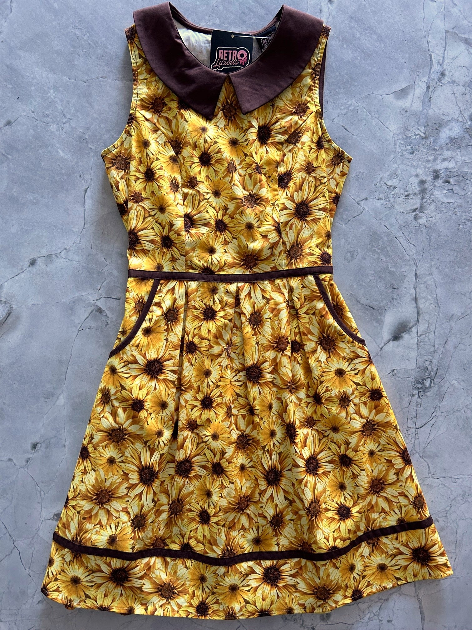 a flat lay of the sunflower honey collared dress