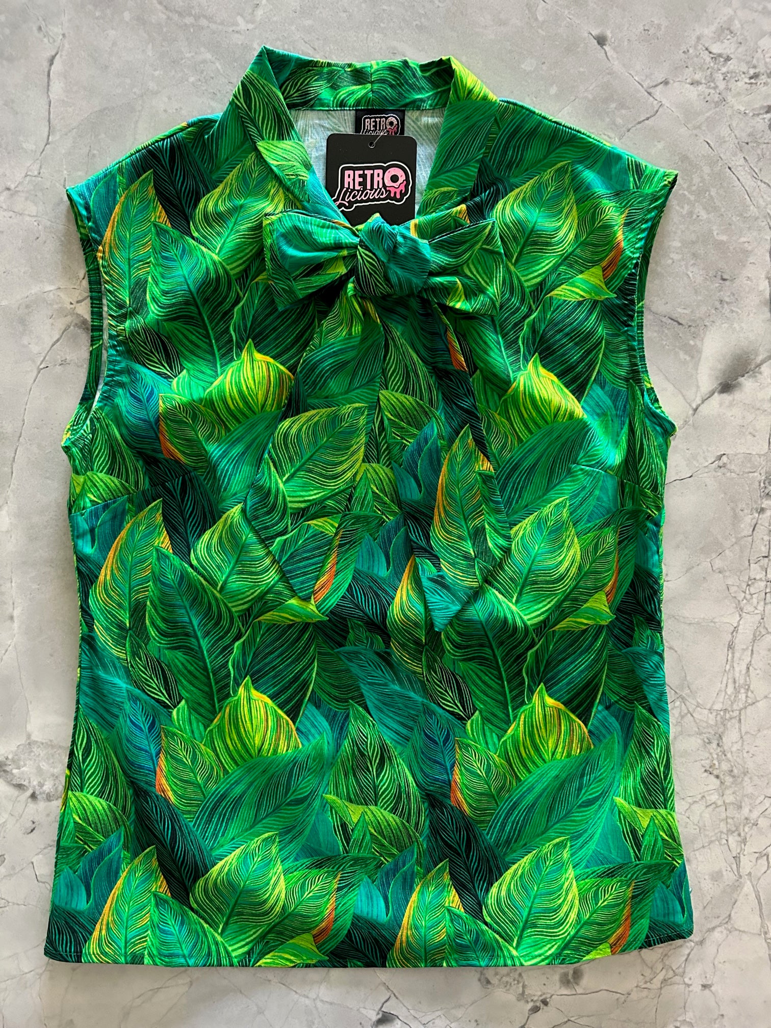a flay lay of our bow tie blouse with leaves fabric