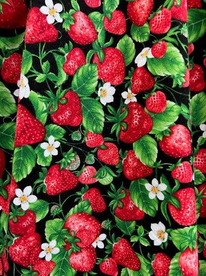 a close up of the fabric showing strawberries and blossoms on a black background