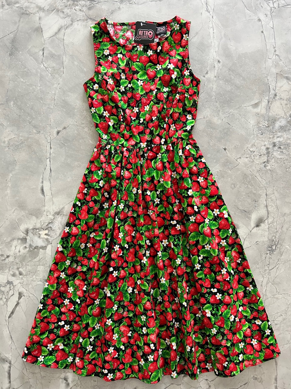 a flat lay of the front of the strawberries midi dress