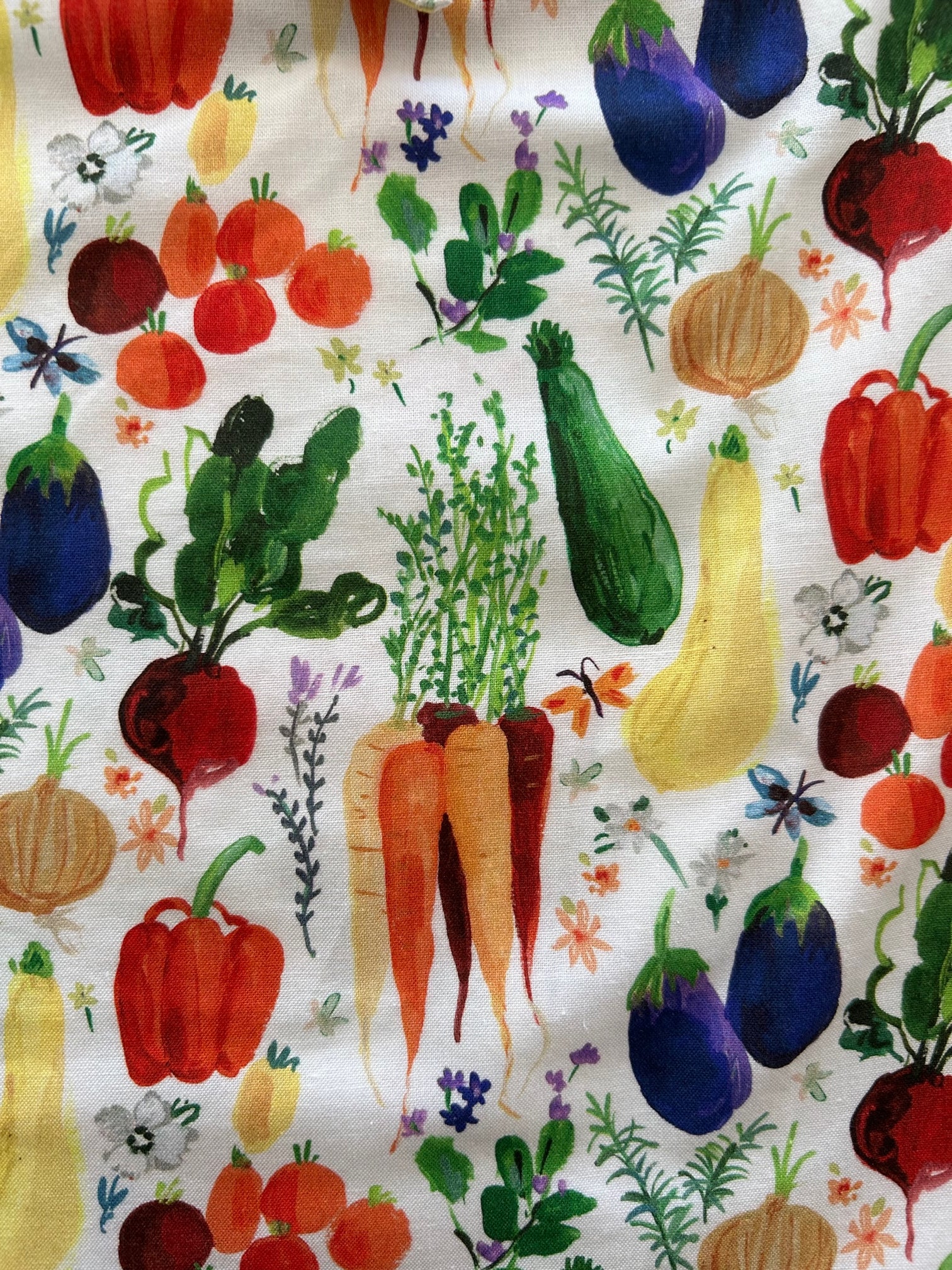 a close up of the fabric our farm to table bow fabric showing the veggies