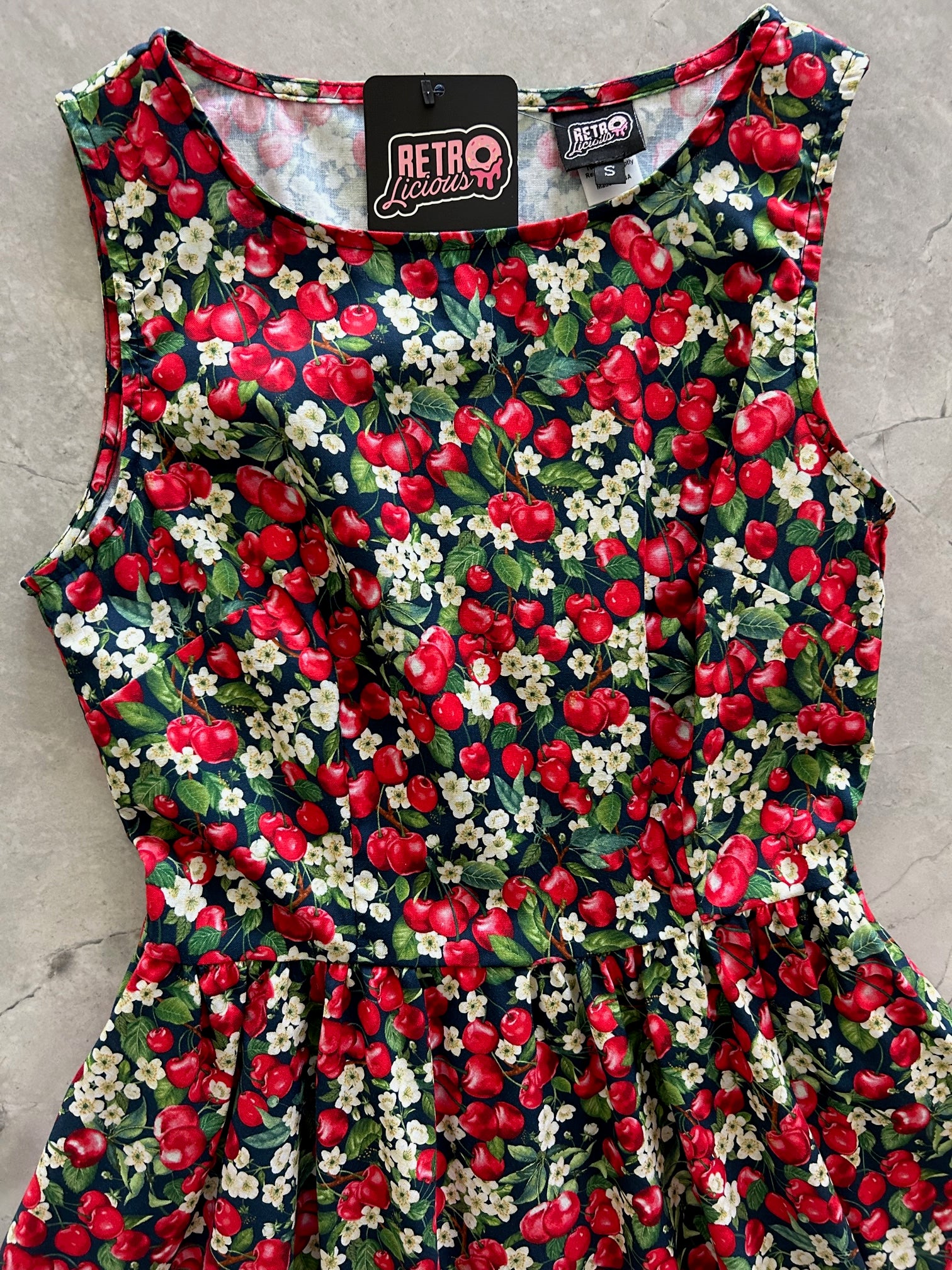 a flat lay of the front of the bodice of the cherry good vintage dress