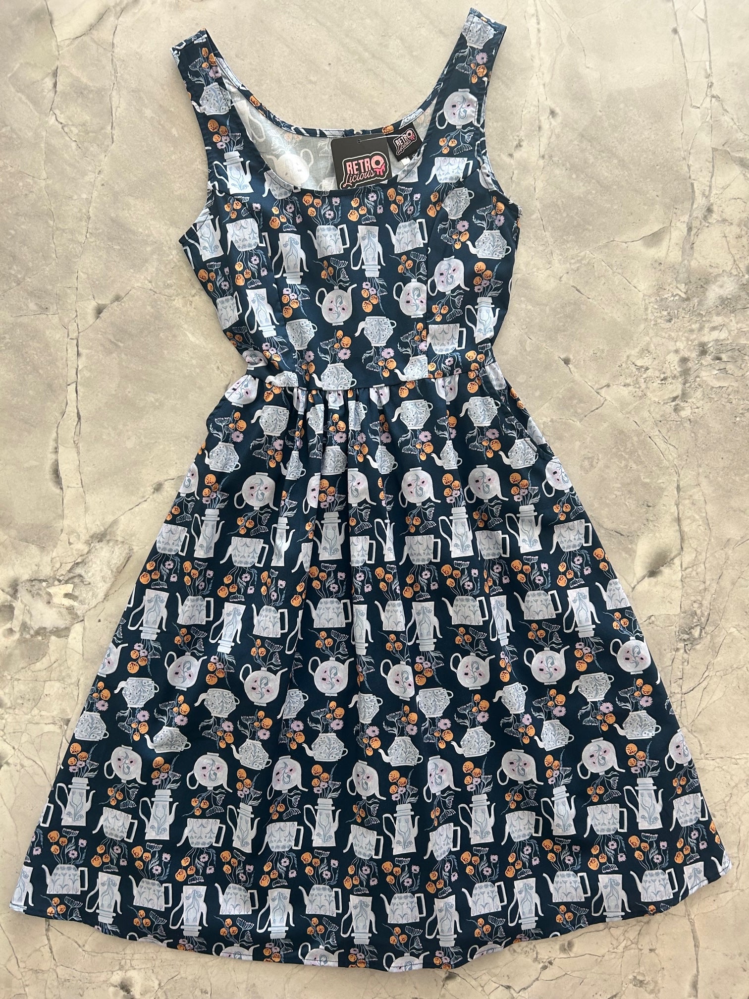 a flat lay of the front of the teapots fit and flare dress