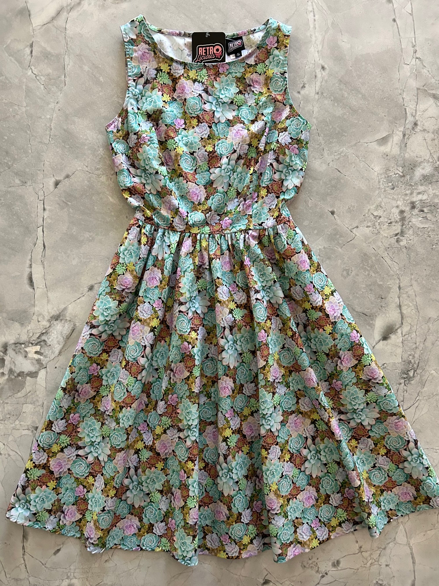 a flat lay of the succulent vintage dress