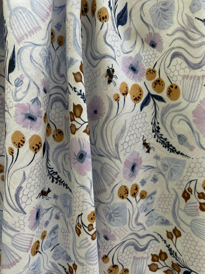 a close up of the fabric of the pollinators vintage dress showing bees and flowers