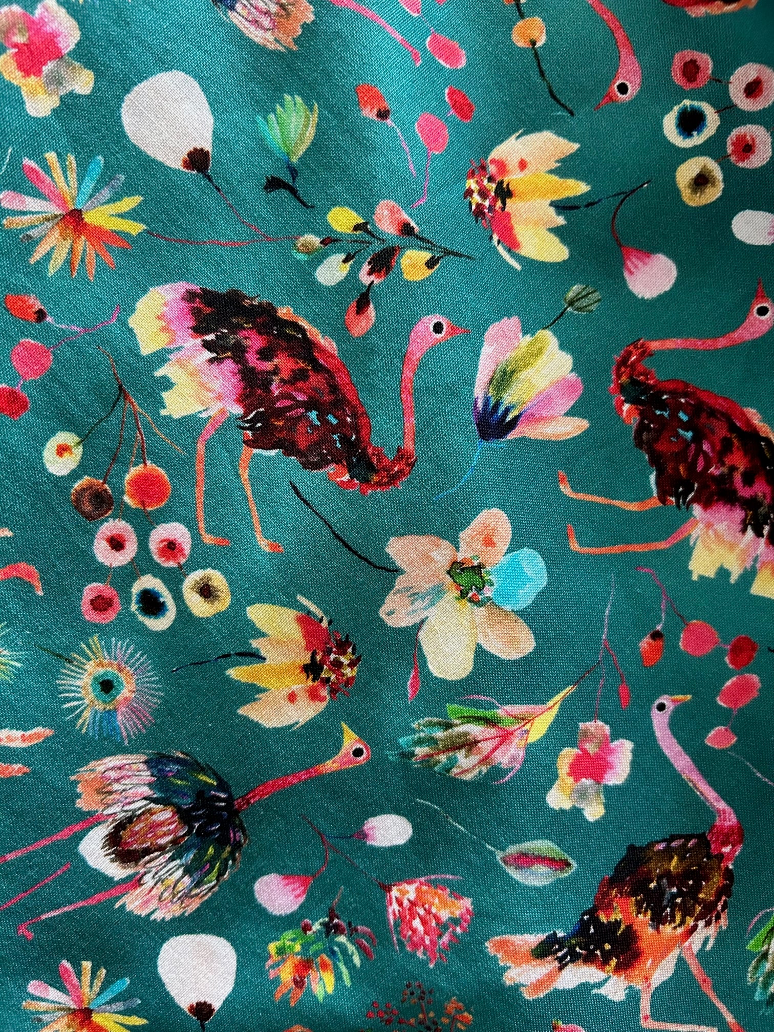 a close up of fabric of ostrich skater skirt showing ostriches and flowers 