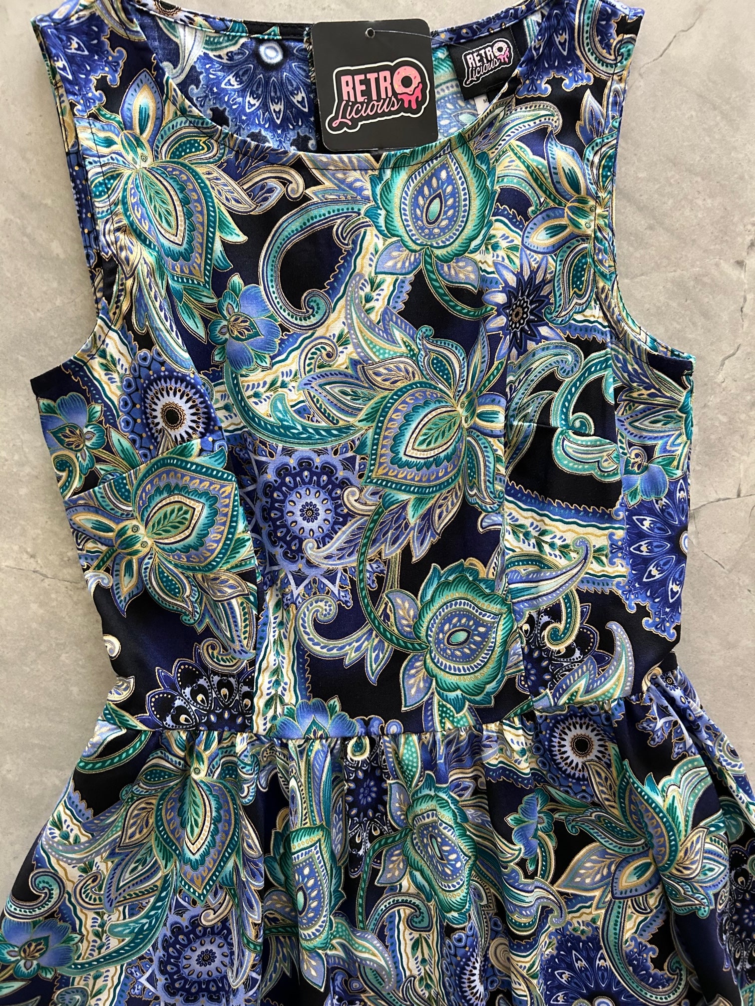 a flat lay of the front of the bodice of the deco floral midi dress