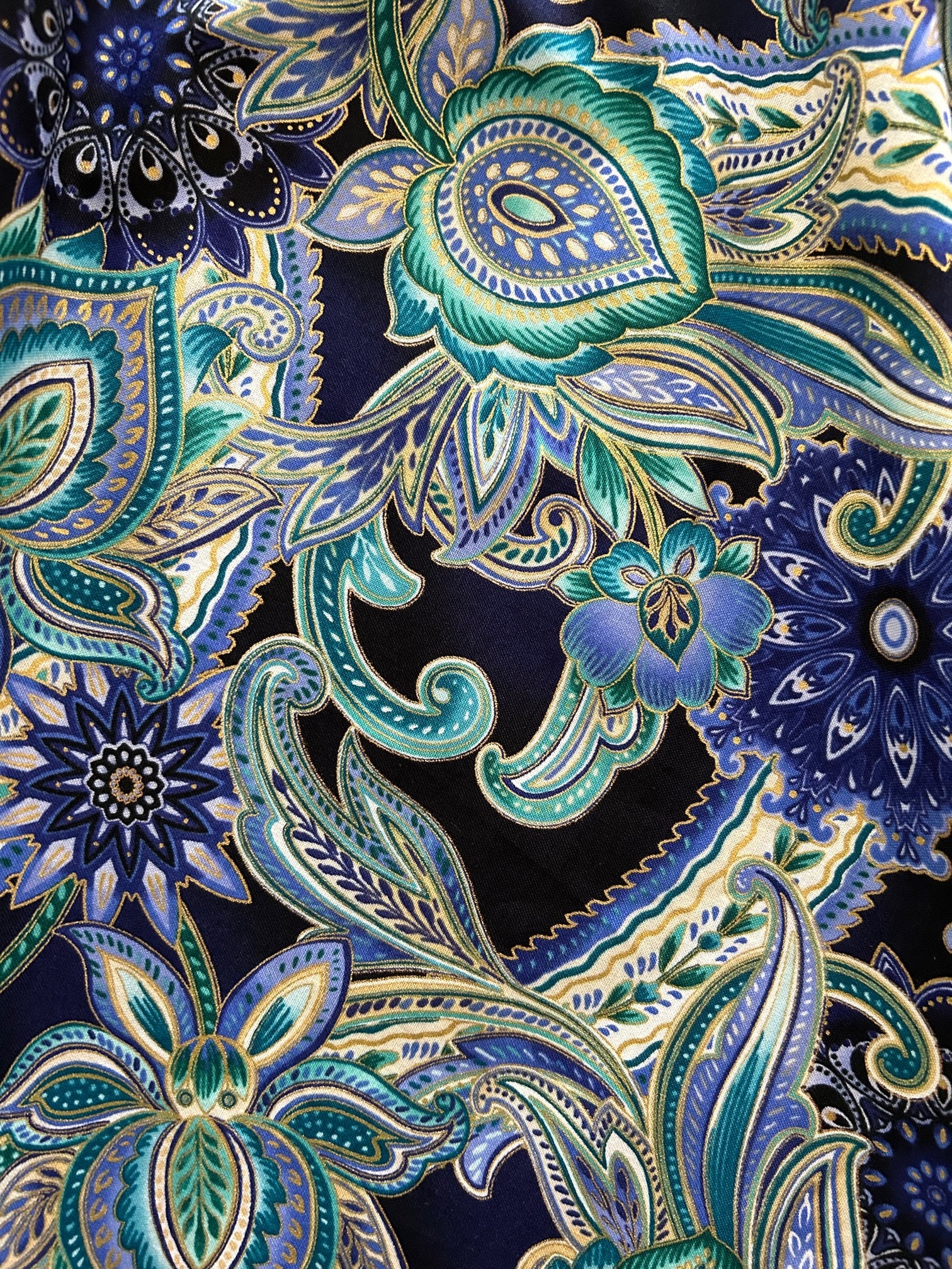 a close up of the fabric of the deco floral midi dress showing the gold metallic details in the floral design