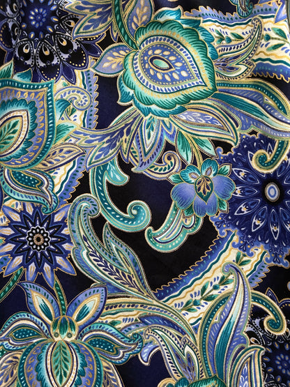 a close up of the fabric of the deco floral midi dress showing the gold metallic details in the floral design