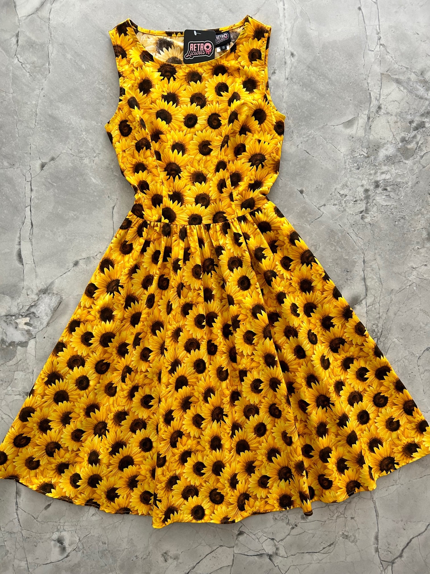 a flat lay of the sunflower vintage dress showing the front of the dress
