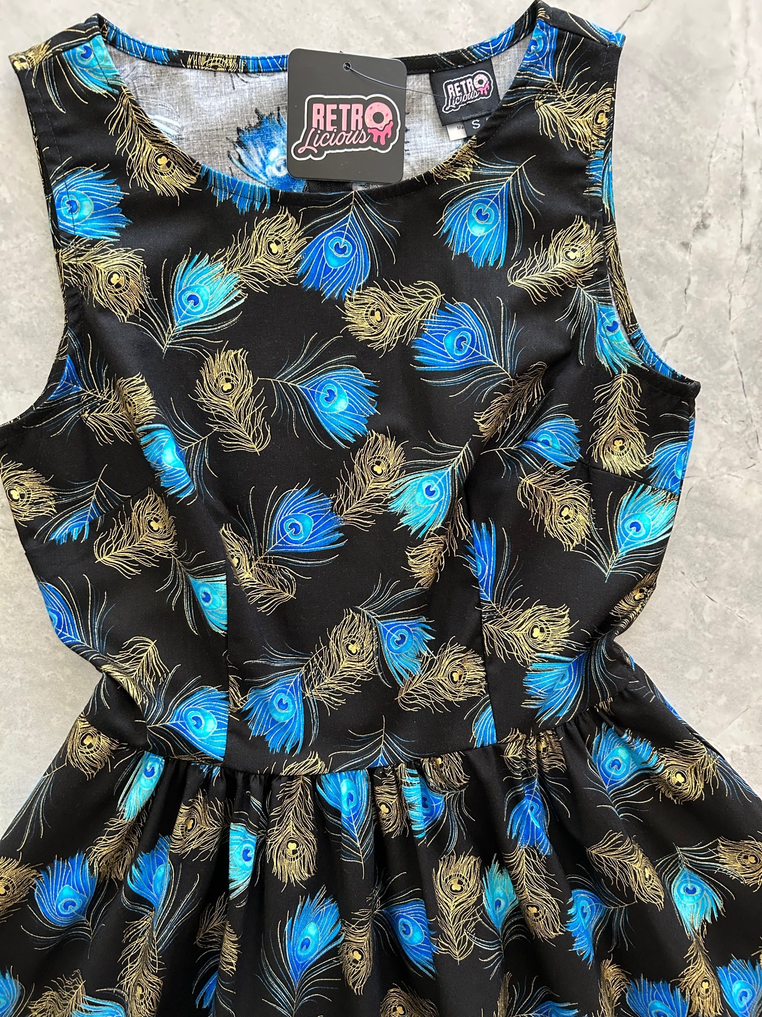 a close up of the bodice of the peacock vintage dress