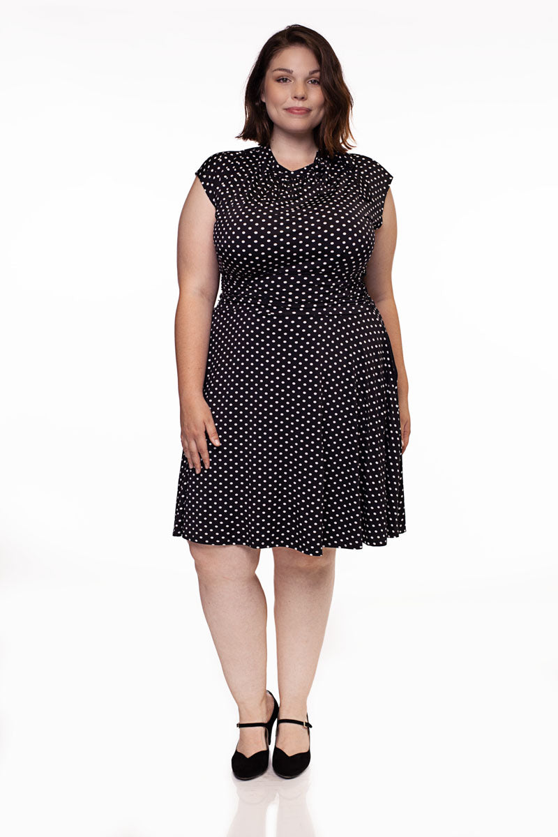 a full size image of a plus size model wearing the bridget bombshell dress in polka dots