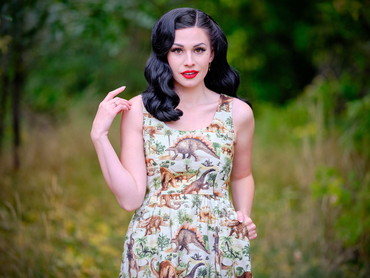 a close up of a model standing in front of trees wearing the prehistoric dress the background is blurred