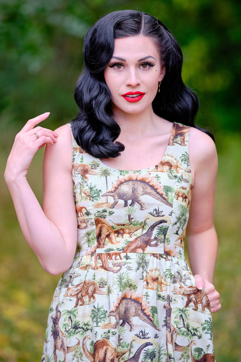 a close up of a model standing in front of trees wearing the prehistoric dress the background is blurred