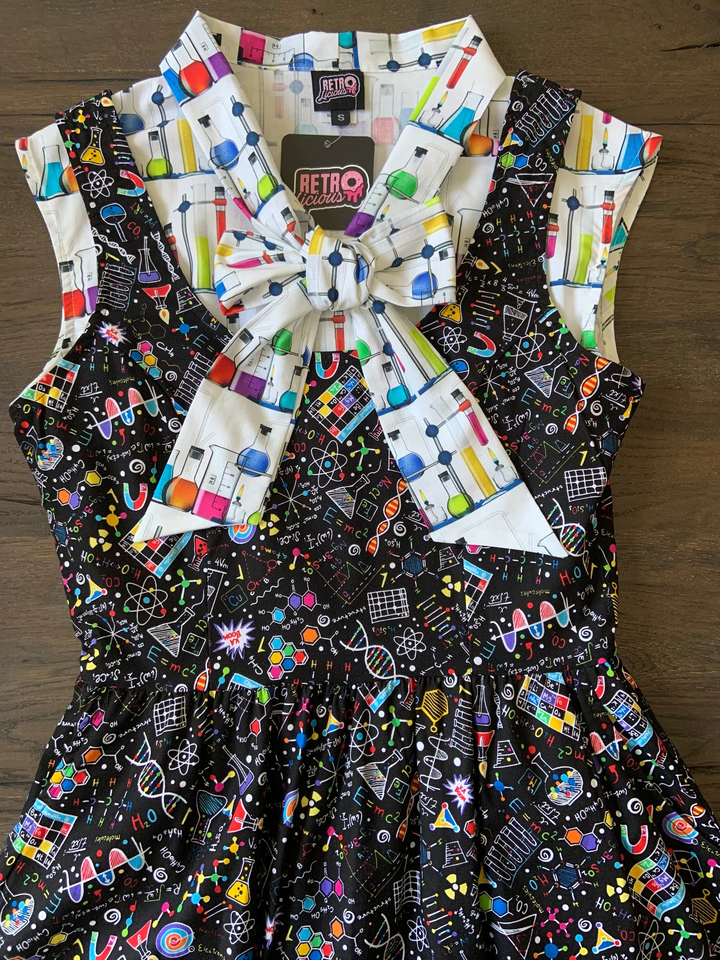 a close up of a bodice of the science fit and flare dress shown with our mad science bow top 